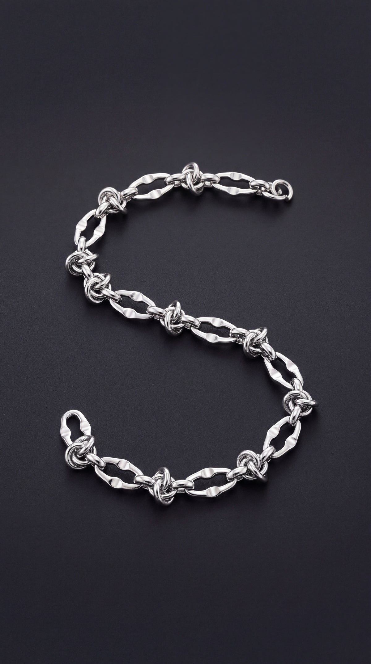 Irregular link bracelet with a knot detail and lobster clasp