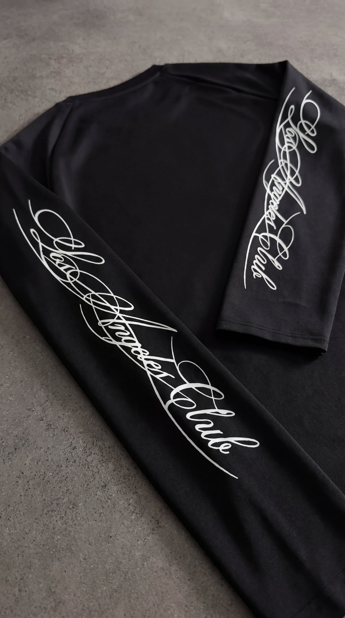 Raglan sleeve tee with cursive lettering down the arms