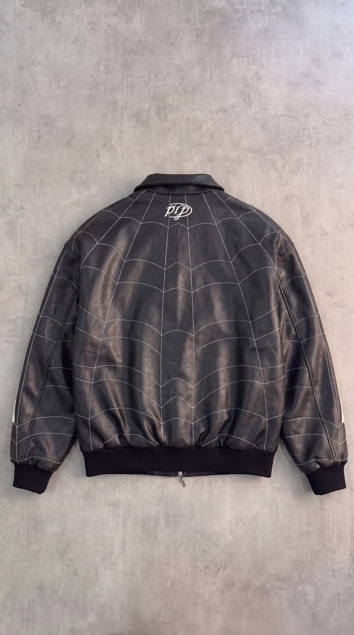 Patchwork PU leather jacket with all-over spider embroidery
