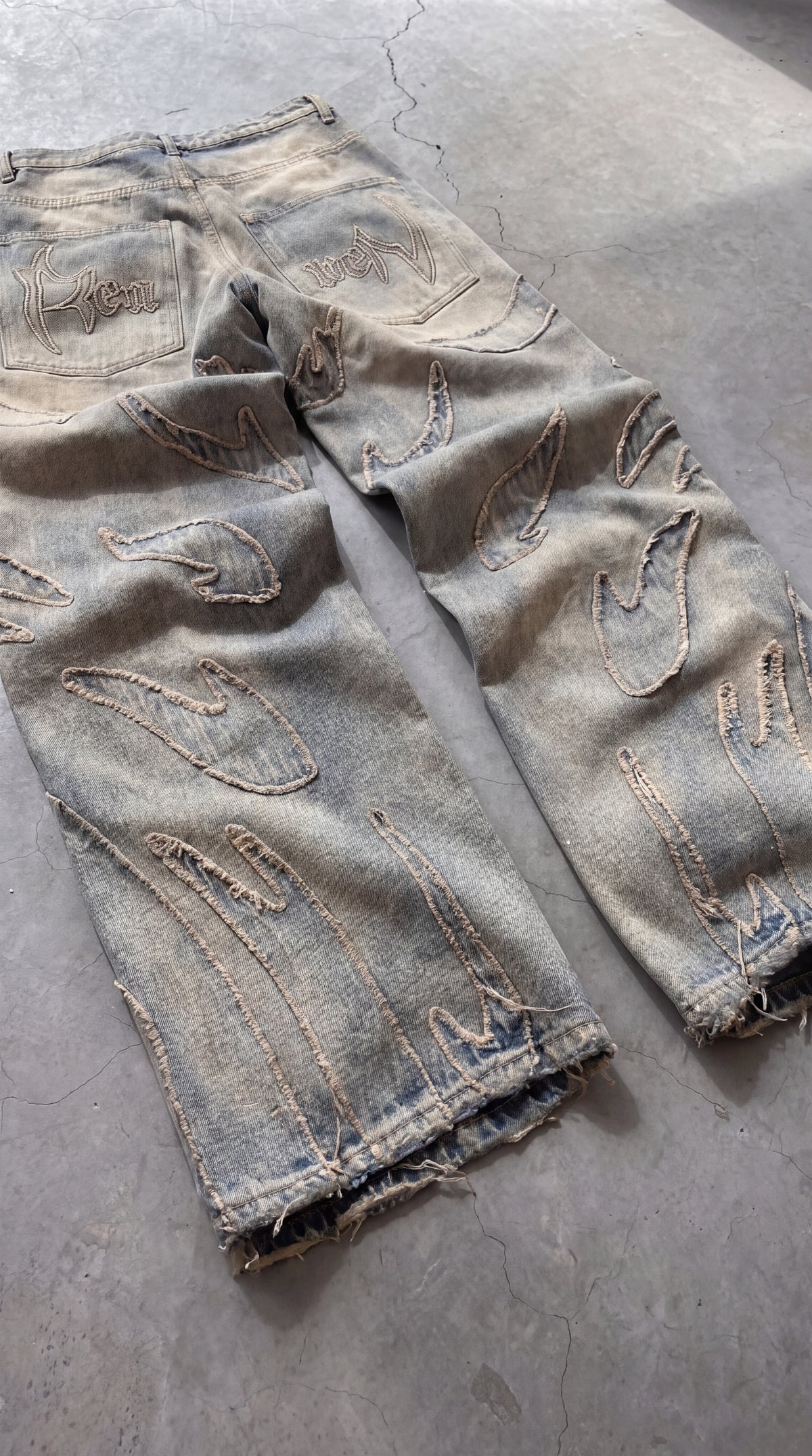 High-rise wide-leg Japanese denim with graphic patches and embroidery