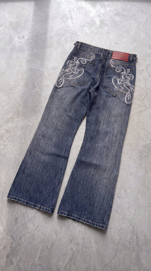 Y2K bootcut denim, close at the thigh and flared from the knee
