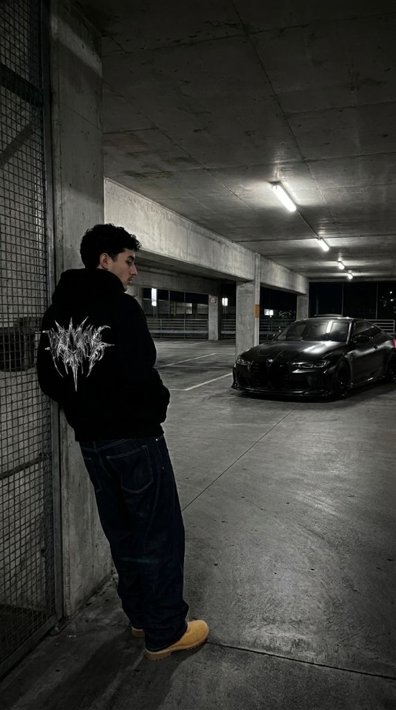 ZYRO Chrome Sigil zip hoodie worn with baggy denim in a parking garage